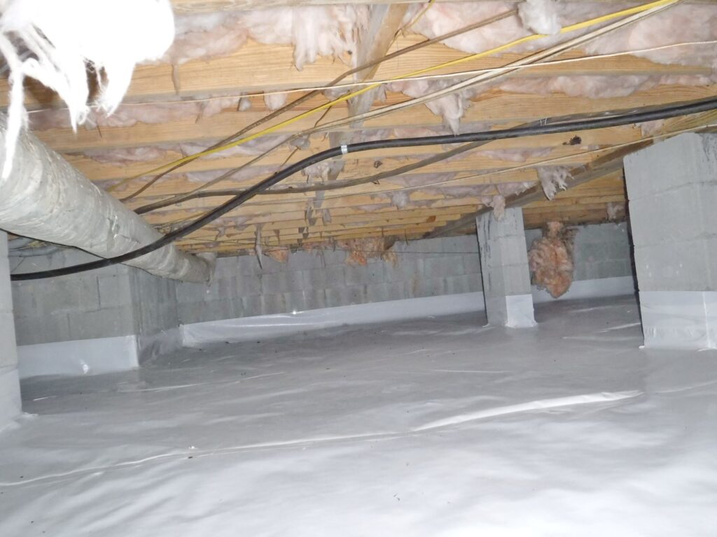 Picture shows example of a crawlspace vapor barrier done right.